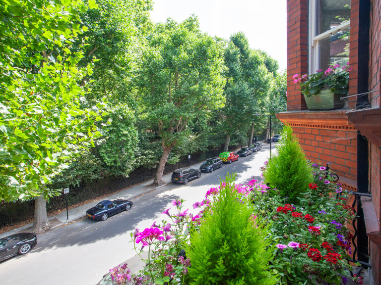 A view of one of the Morshead Mansions balconies in bloom with red, pink and purple flowers