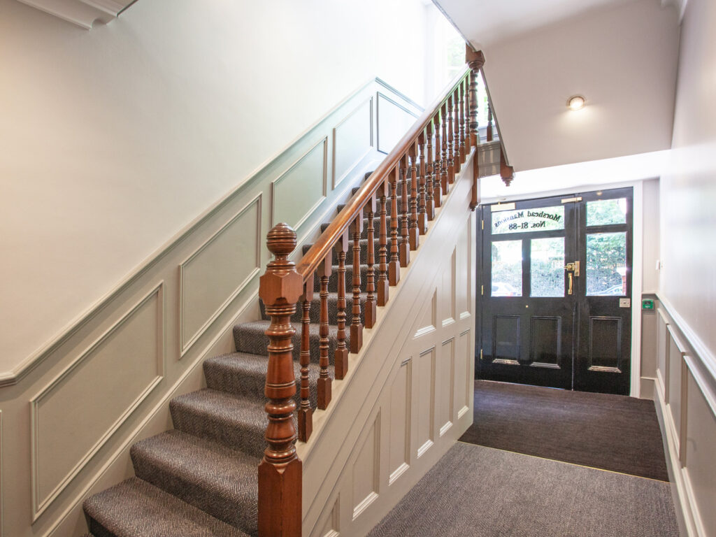 A view of the inside of one of the entrance blocks in Morshead Mansions, showing the front door