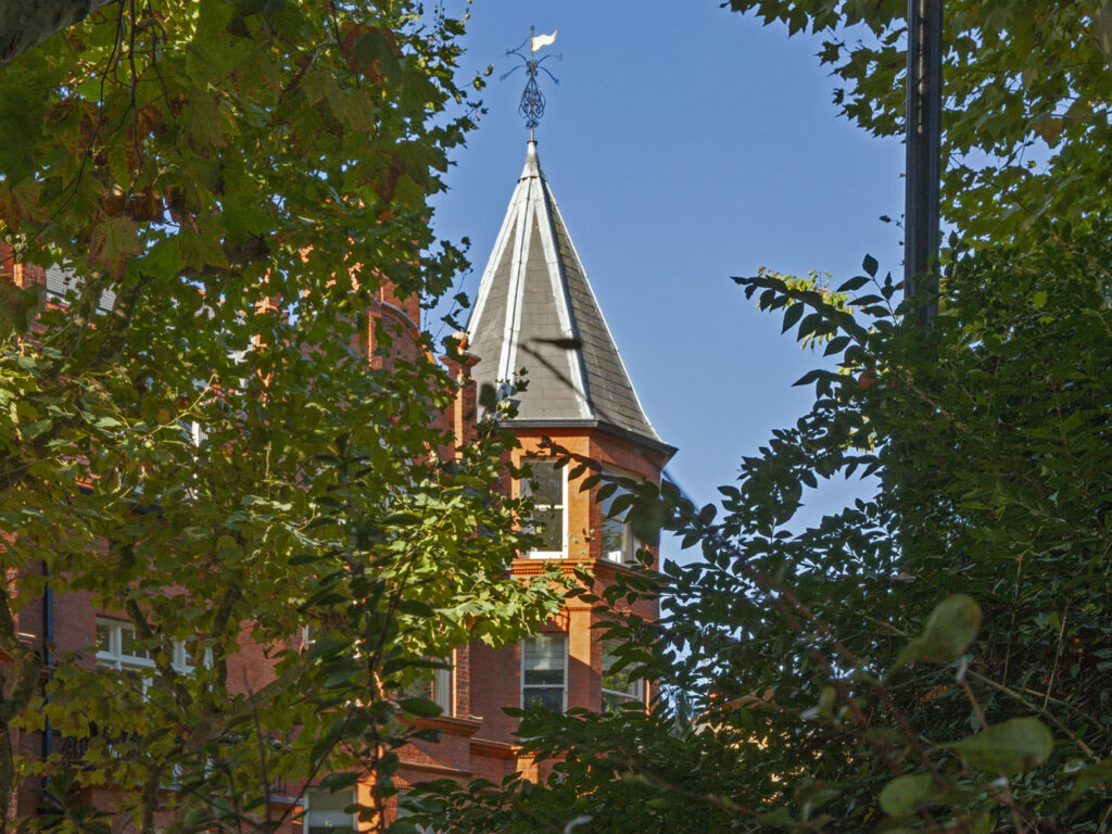 A view of one of the two spires at each end of Morshead Mansions, complete with weather vane