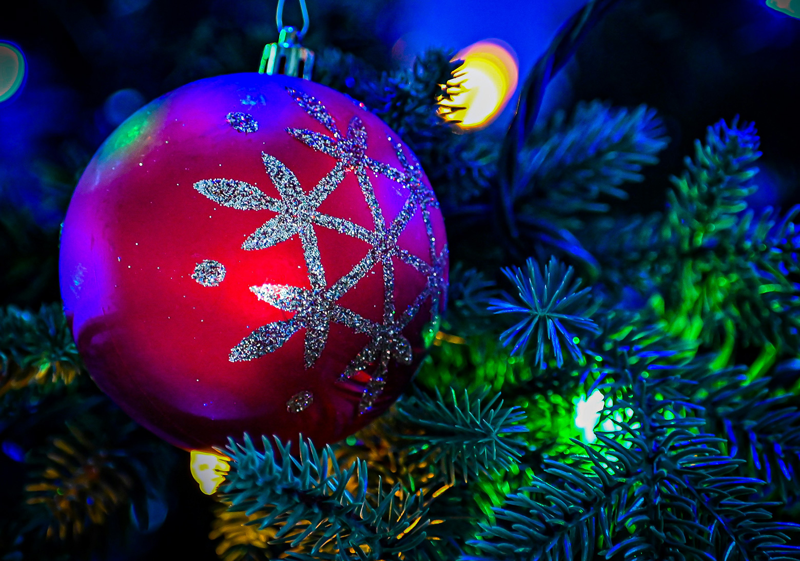 Christmas decorations on a tree in blue light