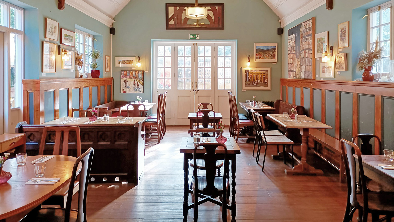 An interior view of The Carlton Tavern, featuring pastel clours and wood panelling