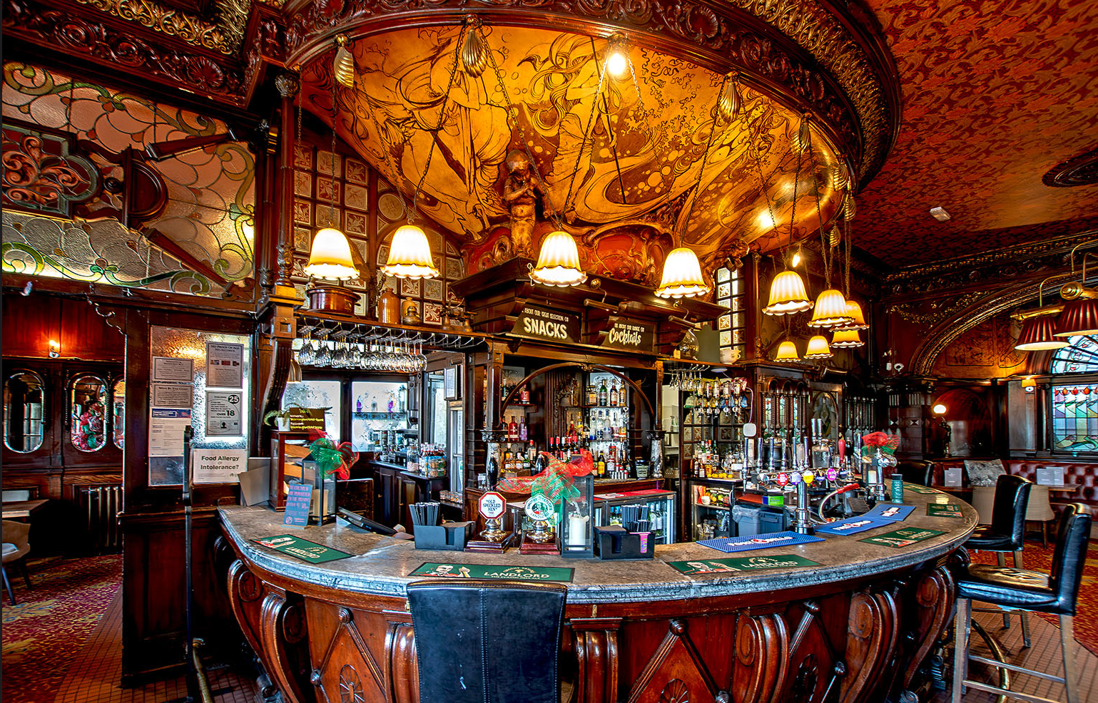 The spectacular bar area of The Warrington Hotel, featuring Art Deco fittig and lighting and rich colours. A truly ourstanding Maida Vale pub