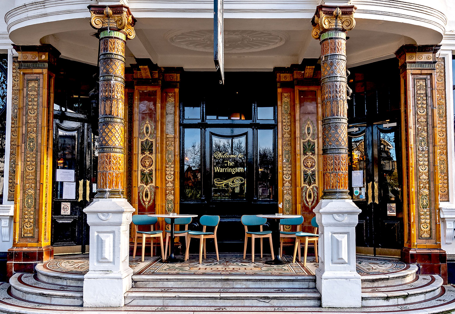 The entrance to The Warrington Hotel, featuring mosaic flooring and marble pillars. A truly ourstanding Maida Vale pub